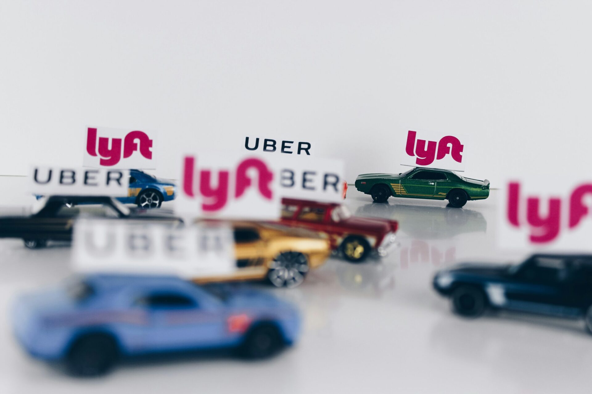 The ride-sharing wars! Uber and Lyft conceptual road concept using toy cars.