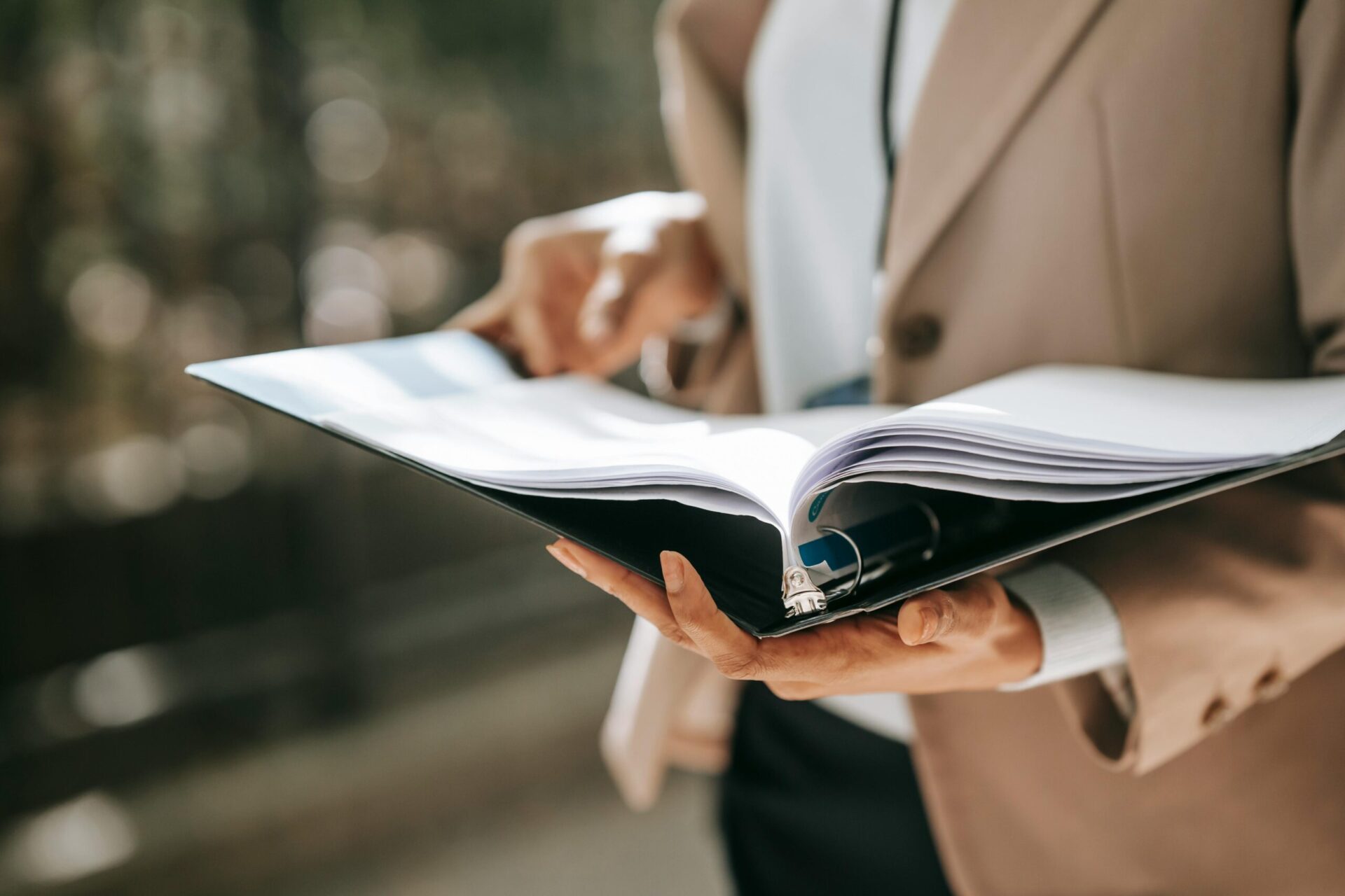 Anonymous businesswoman with papers in folder