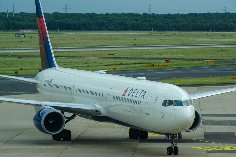 white Delta airplane on airport